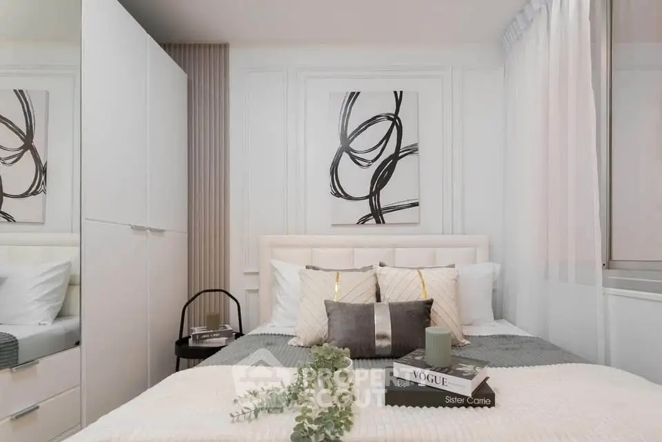 Elegant bedroom with modern decor and cozy ambiance, featuring stylish artwork and plush bedding.