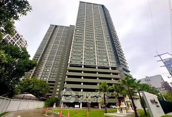 Stunning high-rise building with lush landscaping and modern architecture.