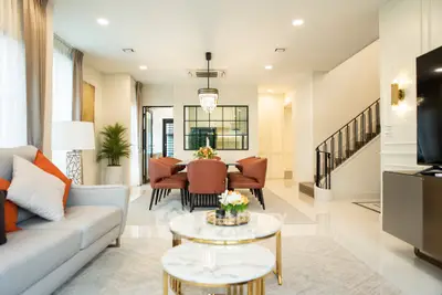 Luxurious open-plan living and dining area with elegant decor and modern lighting.