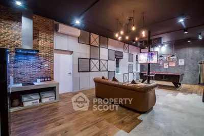 Stylish industrial-style living room with exposed brick and modern lighting