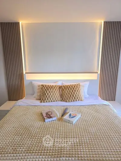 Luxurious bedroom with elegant lighting and cozy bedding, perfect for relaxation.
