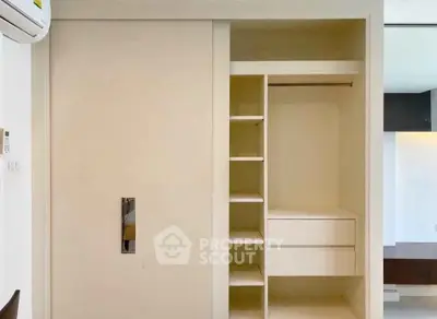 Spacious built-in wardrobe with sliding doors and ample storage space