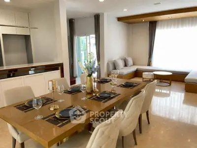 Luxurious open-plan living and dining area with elegant decor and ample natural light.