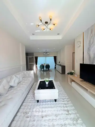 Luxurious living room with elegant white decor and modern lighting