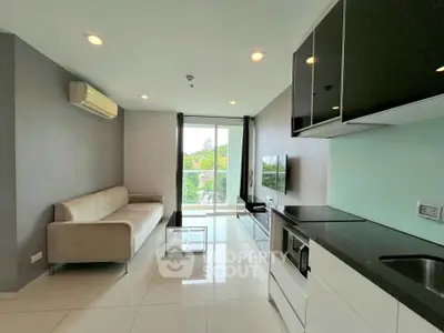 Modern living room with sleek kitchen and balcony view