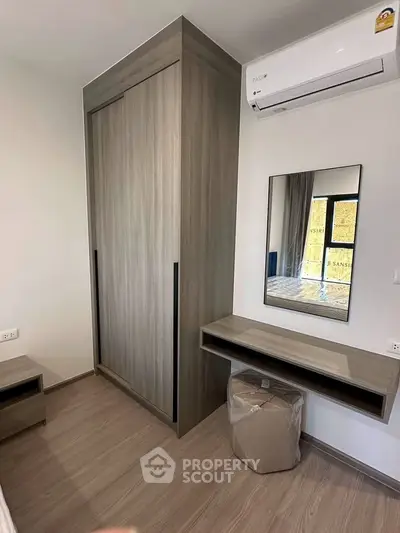 Modern bedroom with sleek wardrobe and air conditioning unit