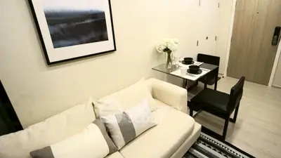 Modern living room with cozy sofa and elegant dining area in a stylish apartment.