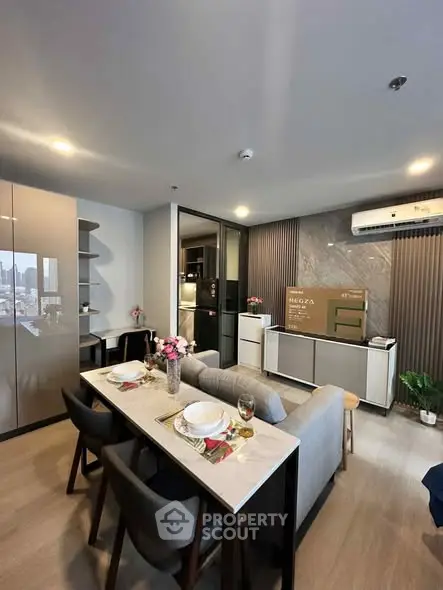 Modern living room with dining area and stylish decor in a contemporary apartment.