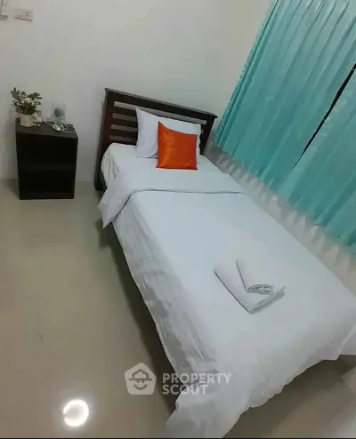 Cozy single bedroom with modern decor and vibrant accents