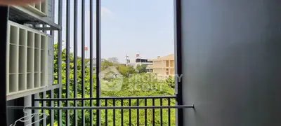 Modern balcony with lush green view and sleek railing design.