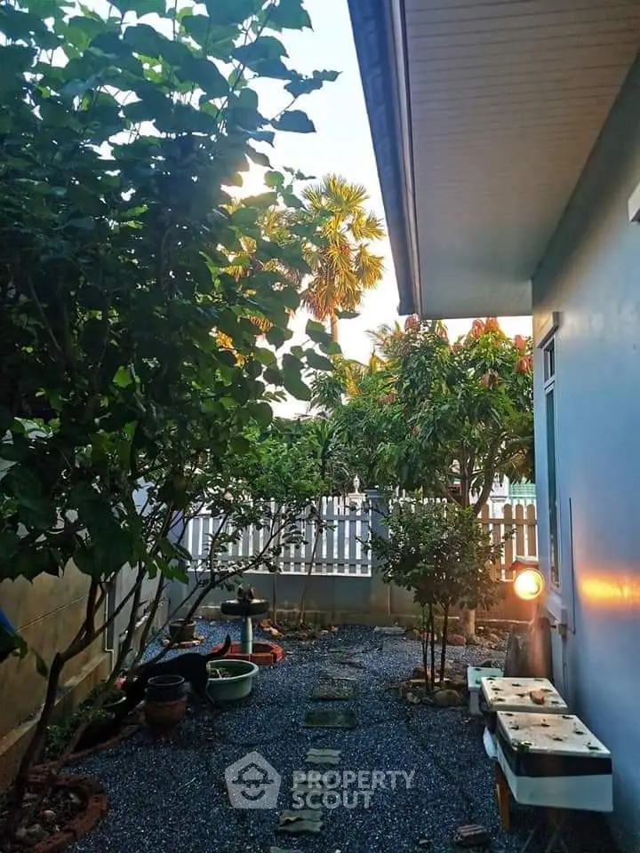 Charming garden with lush greenery and cozy outdoor seating area