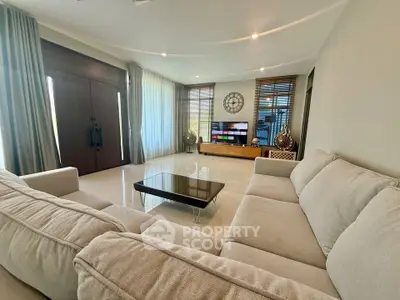 Spacious living room with modern decor and large windows for natural light.