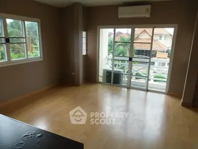 Spacious living room with large windows and balcony view in modern home