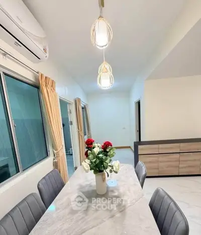Elegant dining area with modern lighting and stylish decor in a contemporary home.