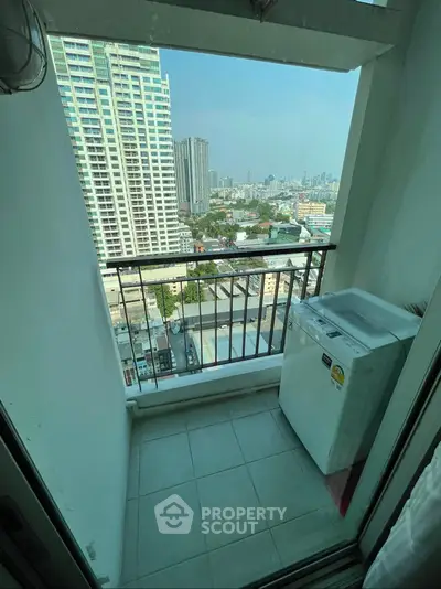 High-rise balcony with city view and washing machine, perfect for urban living.