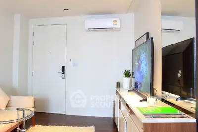 Modern living room with sleek furniture and wall-mounted TV