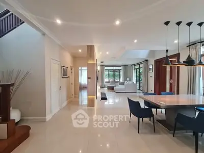 Spacious modern living room with elegant dining area and stylish lighting