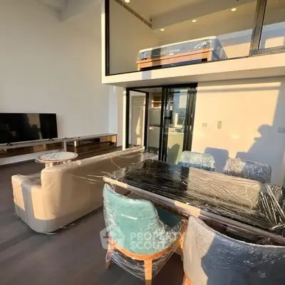 Modern duplex living room with mezzanine and stylish furniture