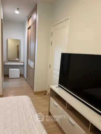 Modern bedroom with TV and vanity in a stylish apartment