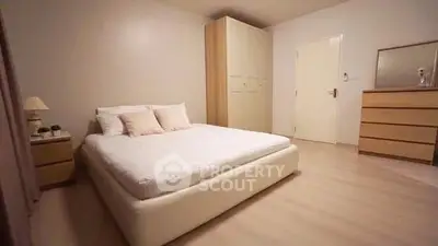 Spacious minimalist bedroom with modern furniture and soft lighting