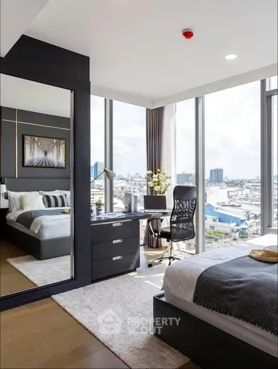 Modern bedroom with city view, featuring sleek furniture and large windows for natural light.