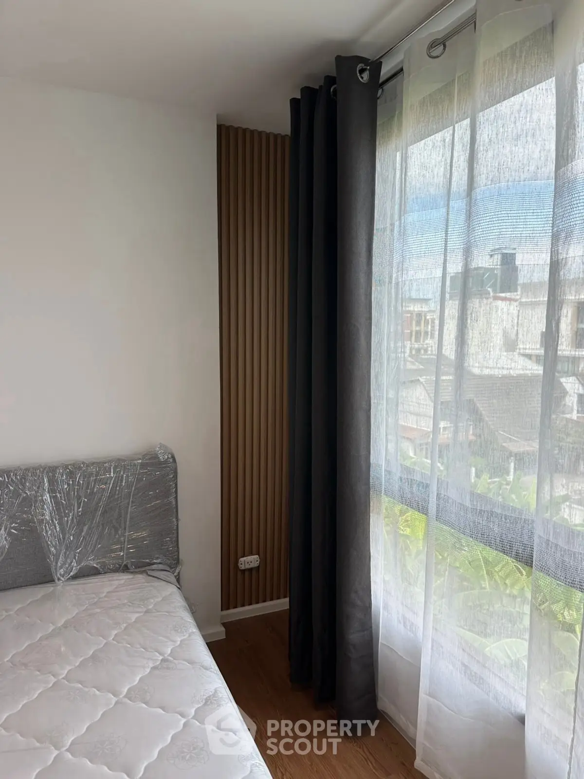 Cozy bedroom with large window and modern decor