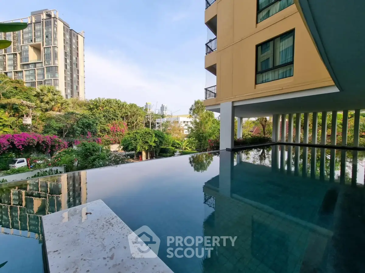 Luxurious apartment with stunning infinity pool and lush garden view