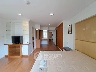 Spacious bedroom with modern furnishings and ample natural light