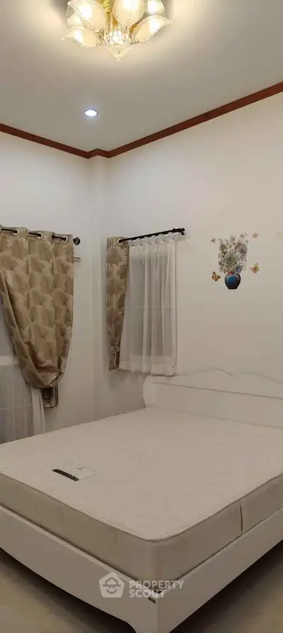 Cozy bedroom with elegant curtains and stylish lighting, perfect for relaxation.