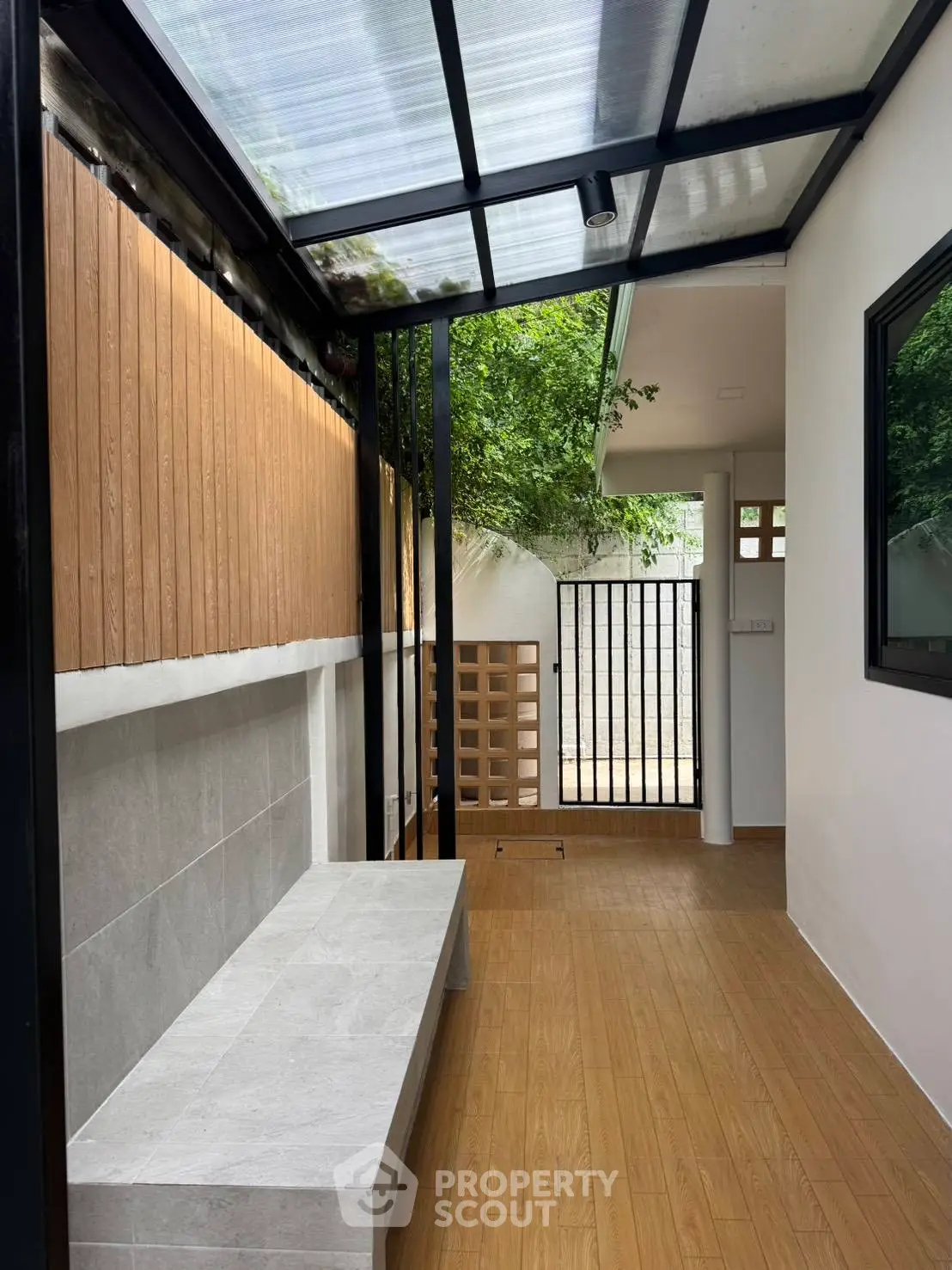 Charming outdoor patio with modern design and natural light, perfect for relaxation and entertaining.
