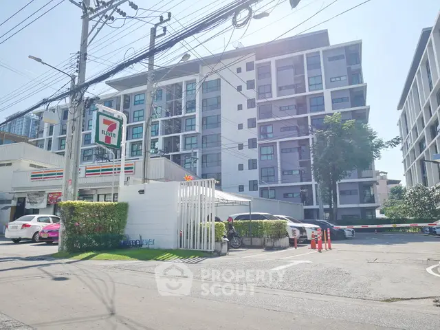 Modern apartment building with convenient 7-Eleven store nearby, ideal urban living location.