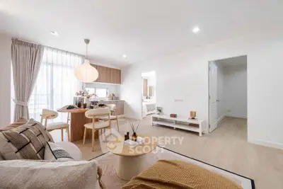 Modern open-plan living room with cozy dining area and natural light