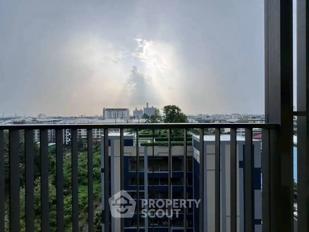 Stunning cityscape view from a high-rise balcony with dramatic sky.