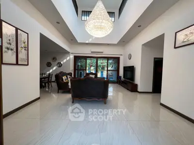 Spacious living room with elegant chandelier and modern decor