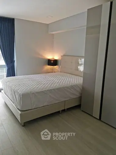 Spacious bedroom with modern design, featuring a large bed with stylish headboard, elegant lighting, and ample wardrobe space, perfect for relaxation.