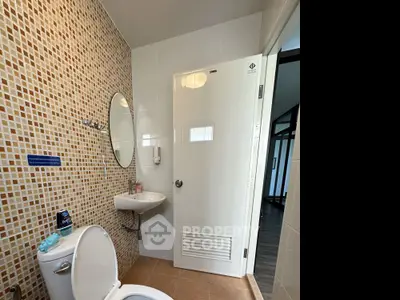 Modern bathroom with mosaic tiles and sleek fixtures