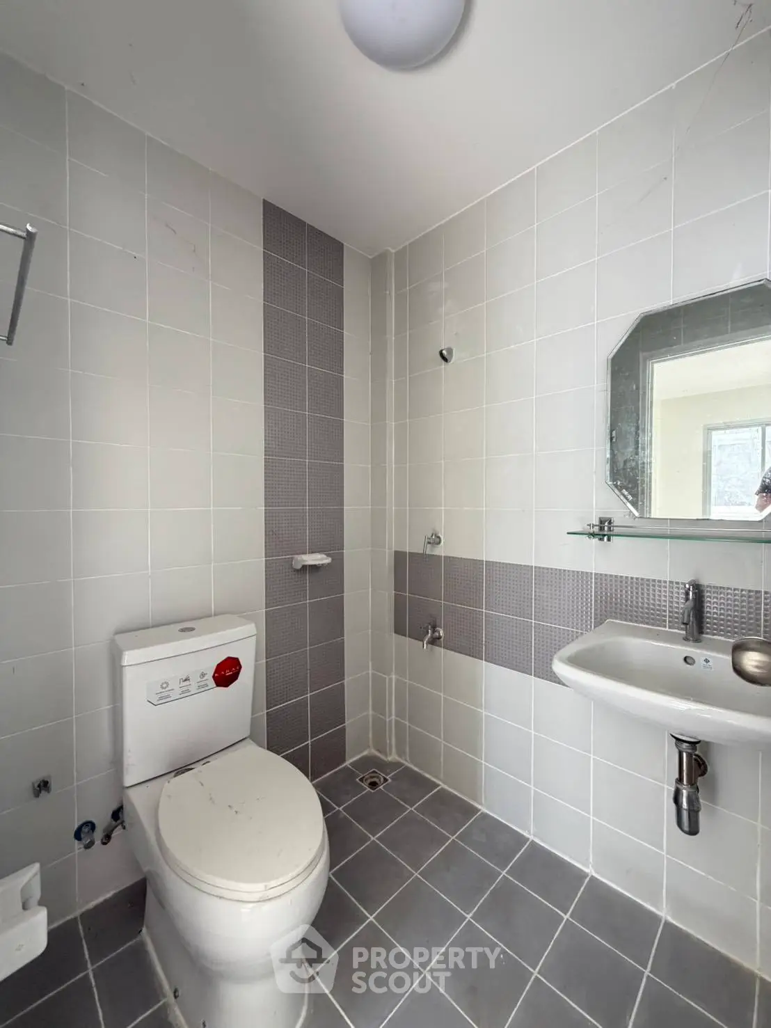 Modern bathroom with sleek gray tiles and minimalist fixtures