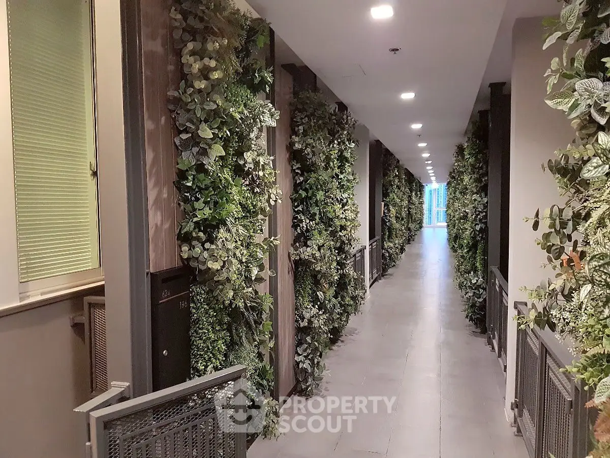 Luxurious hallway with lush greenery walls in modern apartment building