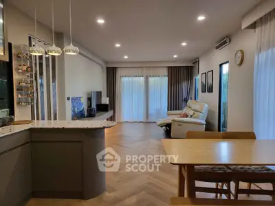 Spacious modern living room with open kitchen and elegant wooden flooring