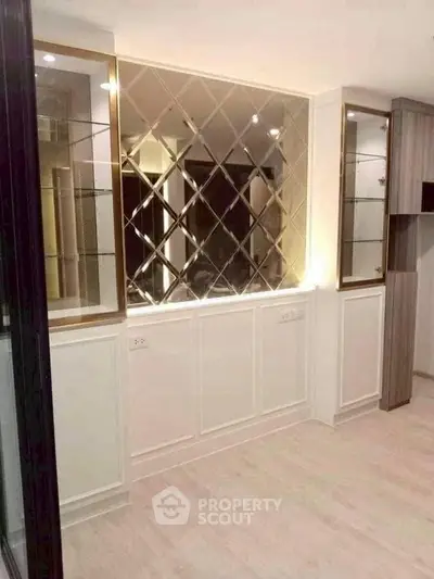 Elegant interior with mirrored wall and built-in shelving, perfect for modern living spaces.