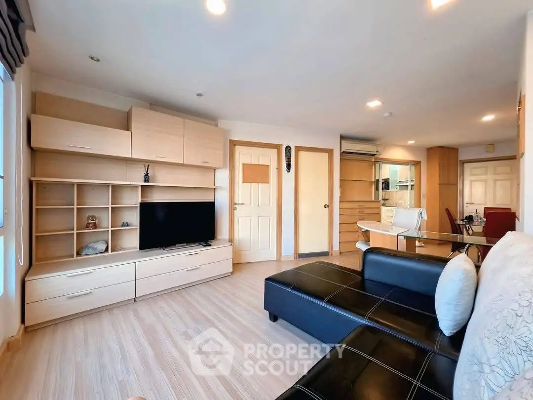Spacious modern living room with sleek furniture and open layout, perfect for relaxation and entertainment.