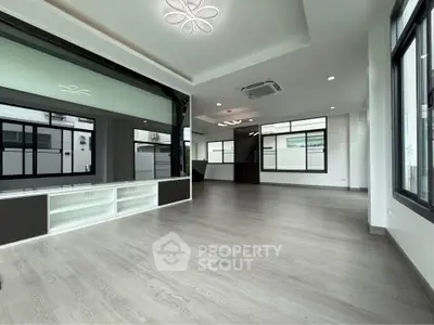Spacious modern living room with large windows and sleek flooring