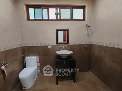 Modern bathroom with stylish sink and tiled walls