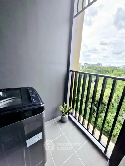 Modern balcony with washing machine and scenic view, perfect for urban living.