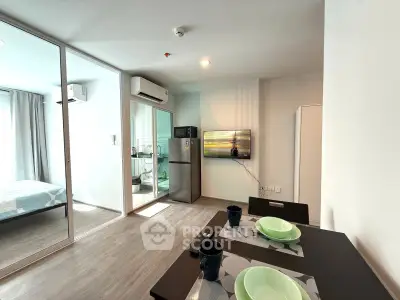 Modern apartment interior with open layout, featuring a cozy dining area and a view into the bedroom.
