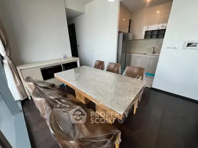 Modern dining area with sleek furniture and open kitchen layout