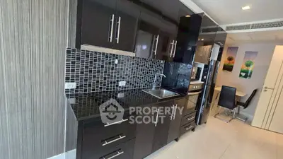 Modern kitchen with sleek black cabinetry and mosaic backsplash