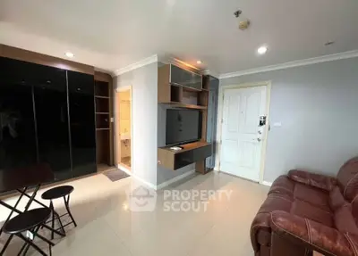 Modern living room with sleek TV setup and cozy leather sofa