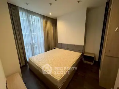 Modern bedroom with large window and stylish furnishings