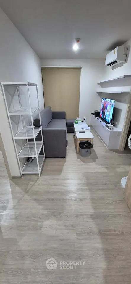 Modern living room with sleek furniture and wall-mounted TV, perfect for cozy relaxation.